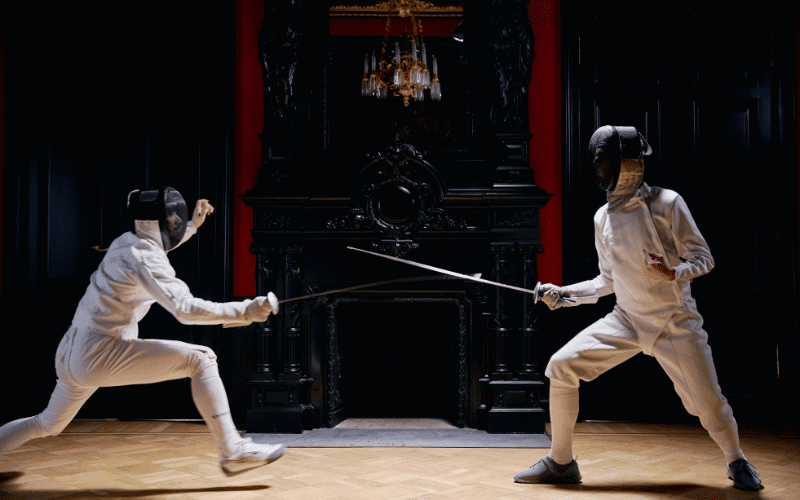 Fencing disciplines and weapons displayed in a German fencing hall