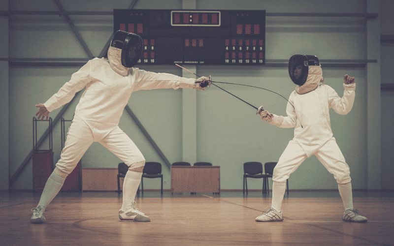 A fencer practices footwork on a non-slippery surface, wearing proper protective gear and using a well-maintained weapon